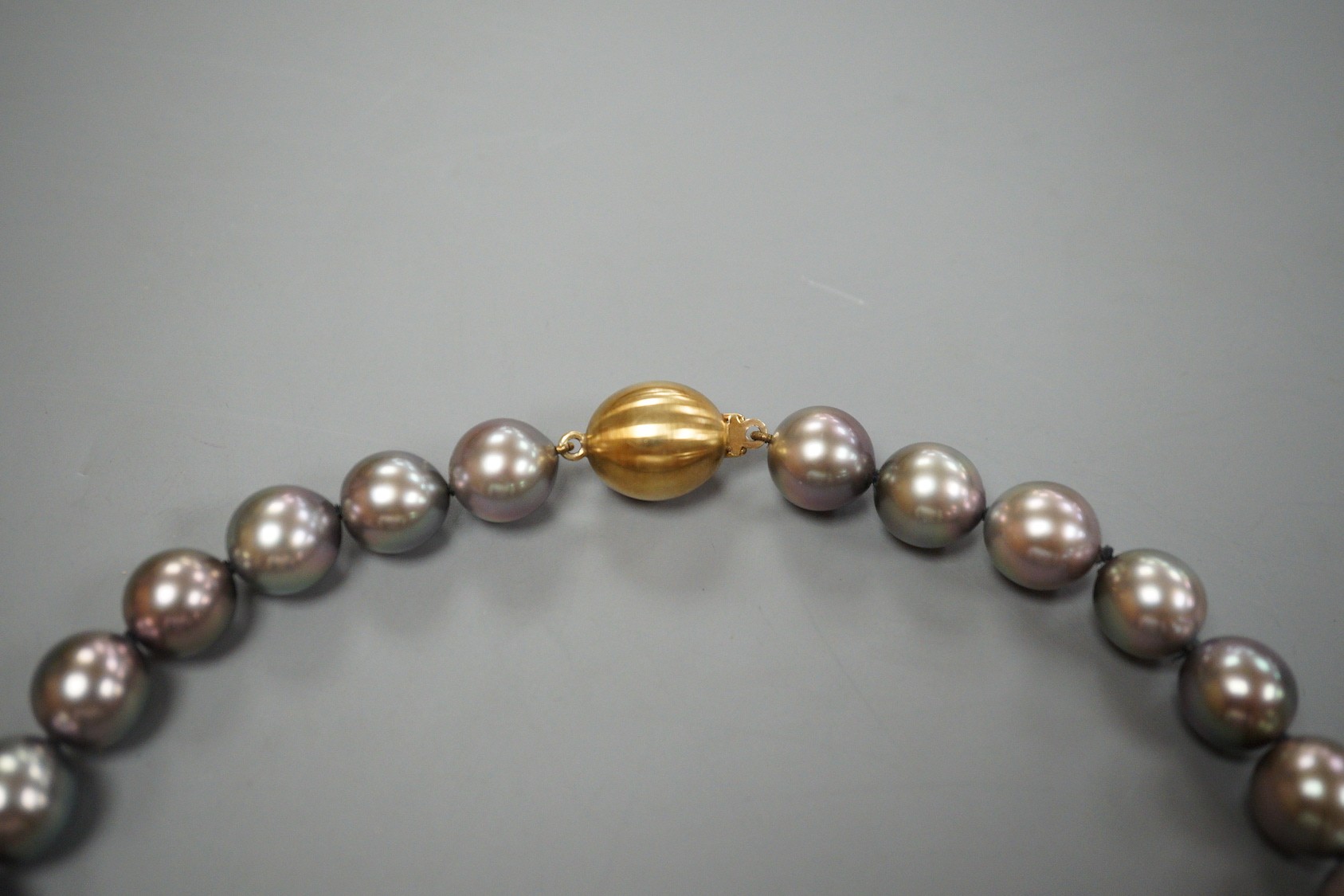 A single strand Tahitian style South Sea pearl necklace, with 585 brushed yellow metal clasp, retailed by Musson
